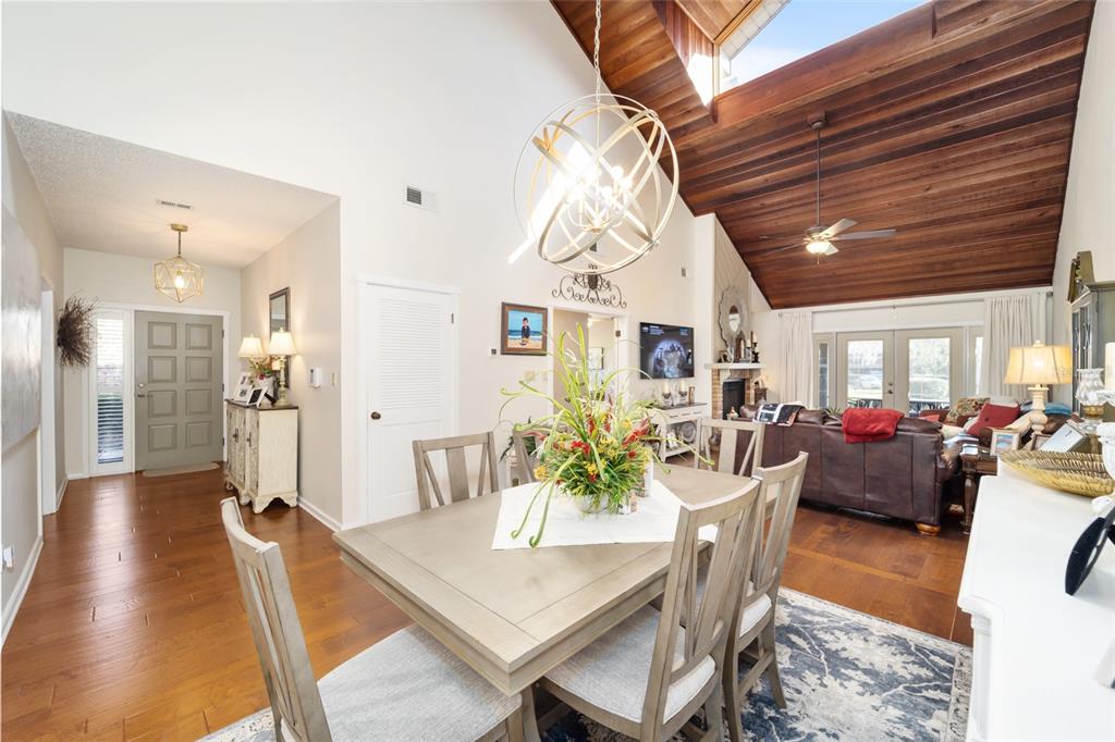 1731 Southeast Clatter Bridge Road Ocala, FL 34471 - Photo 19 of 52 a view of a dining room and livingroom with furniture wooden floor a chandelier