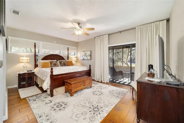 a bed room with a bed mirror and a window