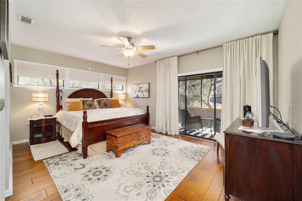 1731 Southeast Clatter Bridge Road Ocala, FL 34471 - Photo 21 of 52 a bed room with a bed mirror and a window