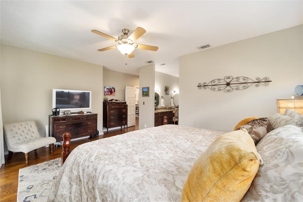 1731 Southeast Clatter Bridge Road Ocala, FL 34471 - Photo 22 of 52 a bed room with a bed and a chair