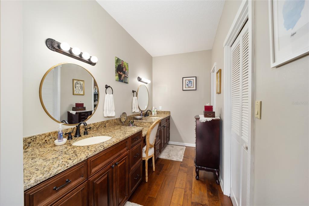 1731 Southeast Clatter Bridge Road Ocala, FL 34471 - Photo 25 of 52 a bathroom with a sink and a mirror