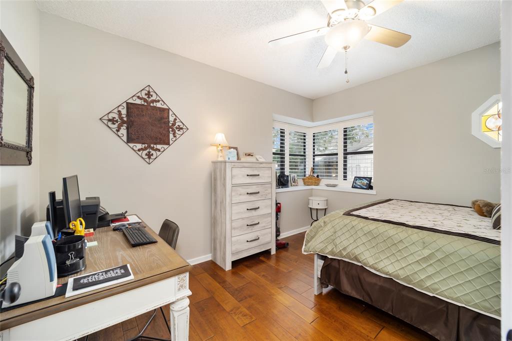 1731 Southeast Clatter Bridge Road Ocala, FL 34471 - Photo 27 of 52 a bed room with a bed and a window