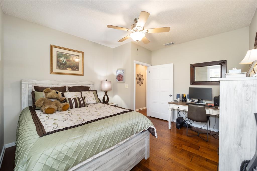 1731 Southeast Clatter Bridge Road Ocala, FL 34471 - Photo 28 of 52 a bedroom with a bed and a chandelier