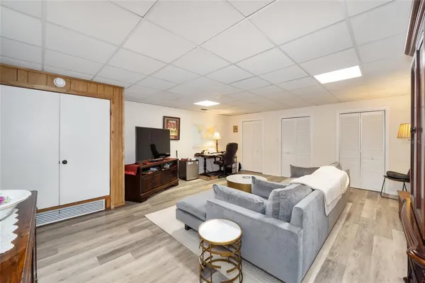 a living room with furniture bathtub and a flat screen tv