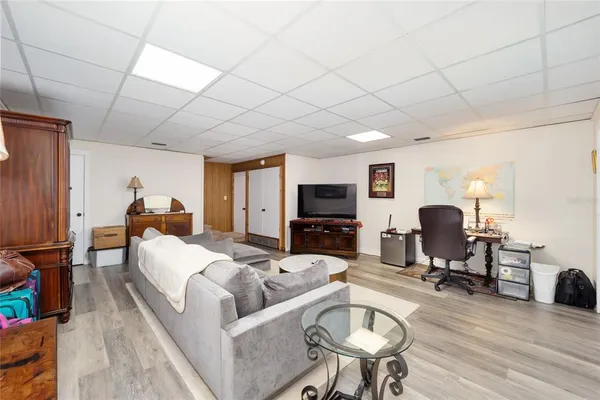 a living room with furniture a flat screen tv and a table