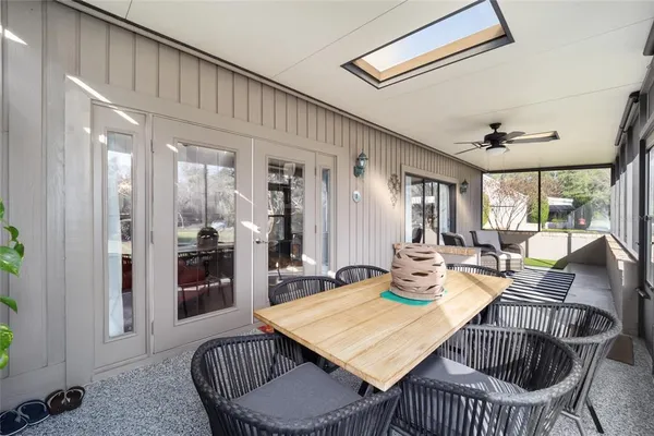a view of an empty room with wooden floor and a table