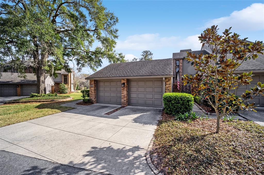 1731 Southeast Clatter Bridge Road Ocala, FL 34471 - Photo 47 of 52 a front view of a house with a yard and garage