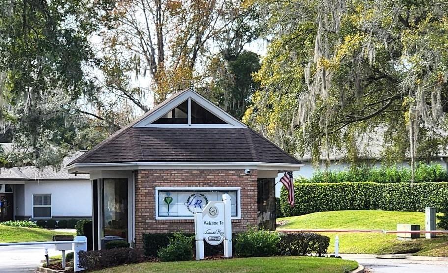 1731 Southeast Clatter Bridge Road Ocala, FL 34471 - Photo 49 of 52 a view of a house with a yard potted plants and large tree