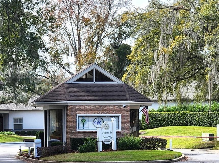 1731 Southeast Clatter Bridge Road Ocala, FL 34471 - Photo 50 of 52 a front view of a house with a yard