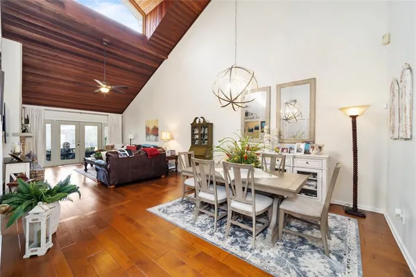 a living room with furniture a chandelier and a table