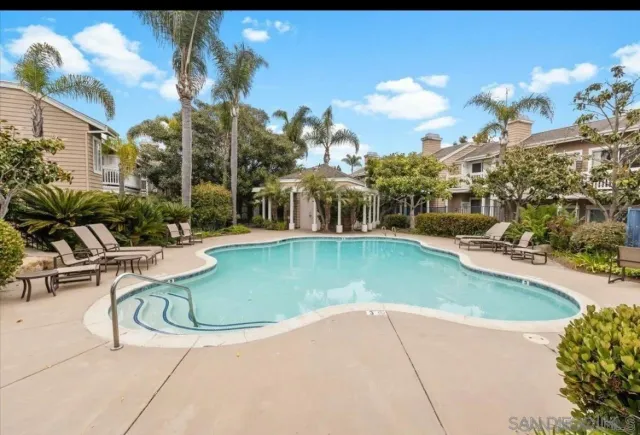 a view of a swimming pool with outdoor seating