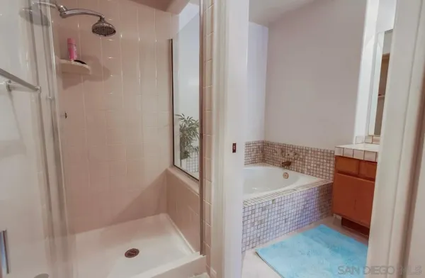 a bathroom with a bathtub and shower