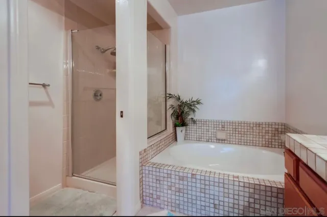 a en suite bathroom with a double vanity sink and a mirror
