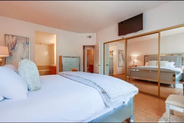 a bedroom with a bed and cabinet