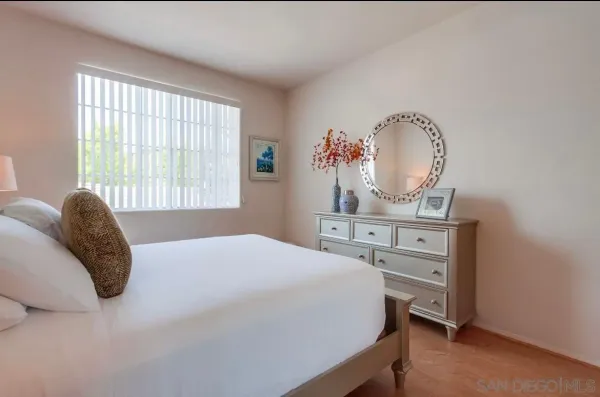 a bedroom with a bed and a lamp