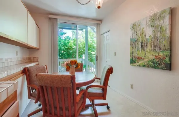 a large kitchen with stainless steel appliances wooden cabinets and a stove top oven