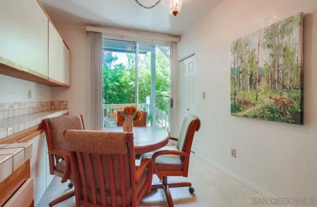 a large kitchen with stainless steel appliances wooden cabinets and a stove top oven