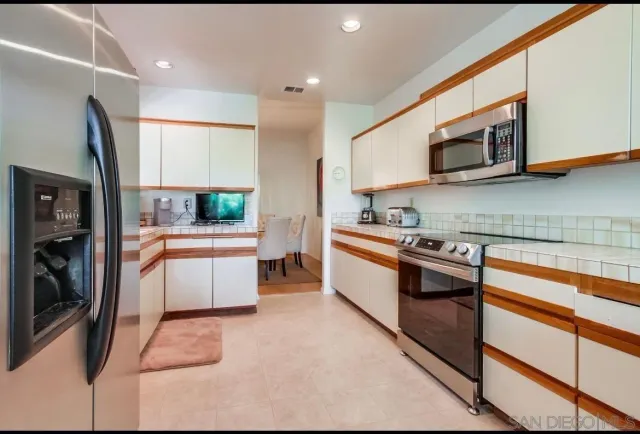a kitchen with stainless steel appliances granite countertop sink microwave and stove