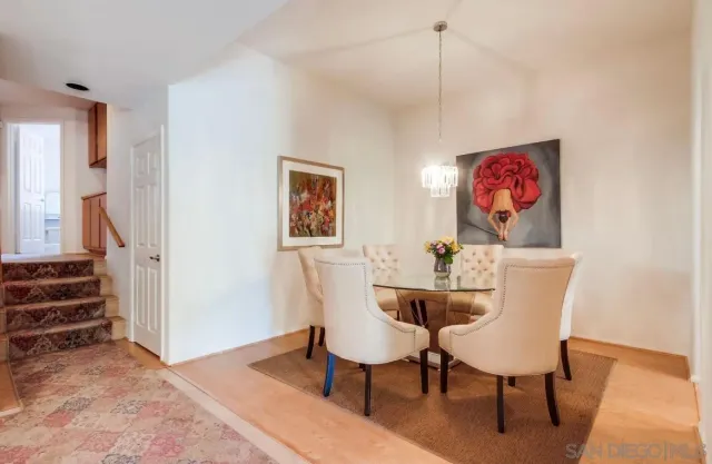 a dining room with furniture and wooden floor