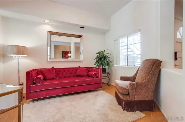 a living room with furniture and a potted plant