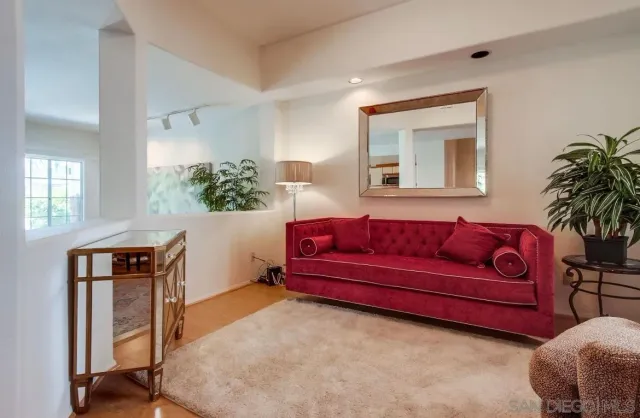 a living room with furniture and a potted plant