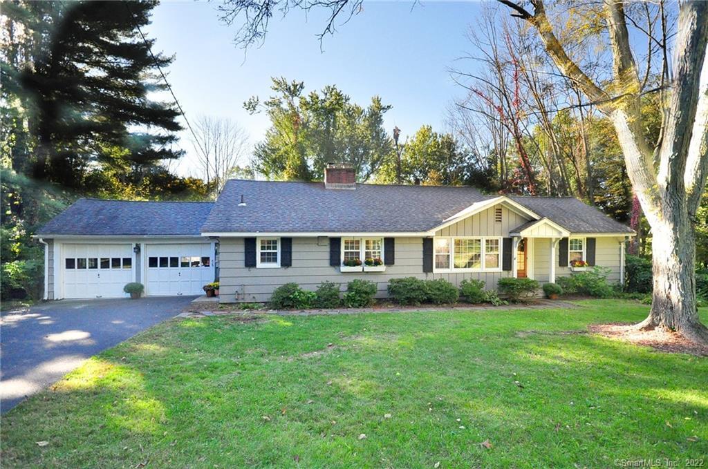 47 Cider Brook Road Avon, CT 06001 - Photo 1 of 1 a front view of a house with a garden and trees