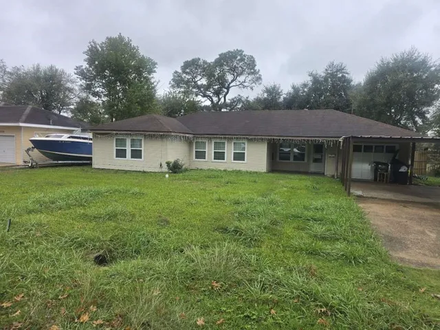 a view of a house with a yard and sitting area