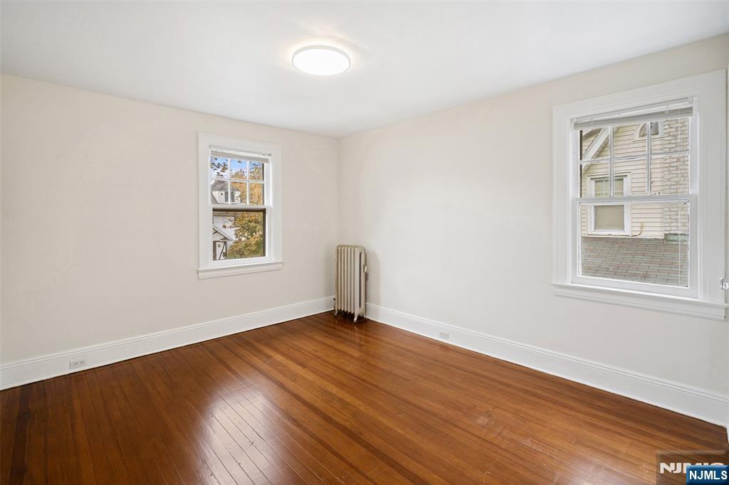 401 Conrad Road Englewood, NJ 07631 - Photo 20 of 42 an empty room with wooden floor and windows