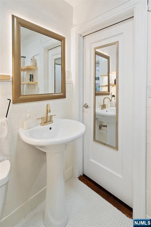 401 Conrad Road Englewood, NJ 07631 - Photo 27 of 42 a bathroom with a sink and a mirror