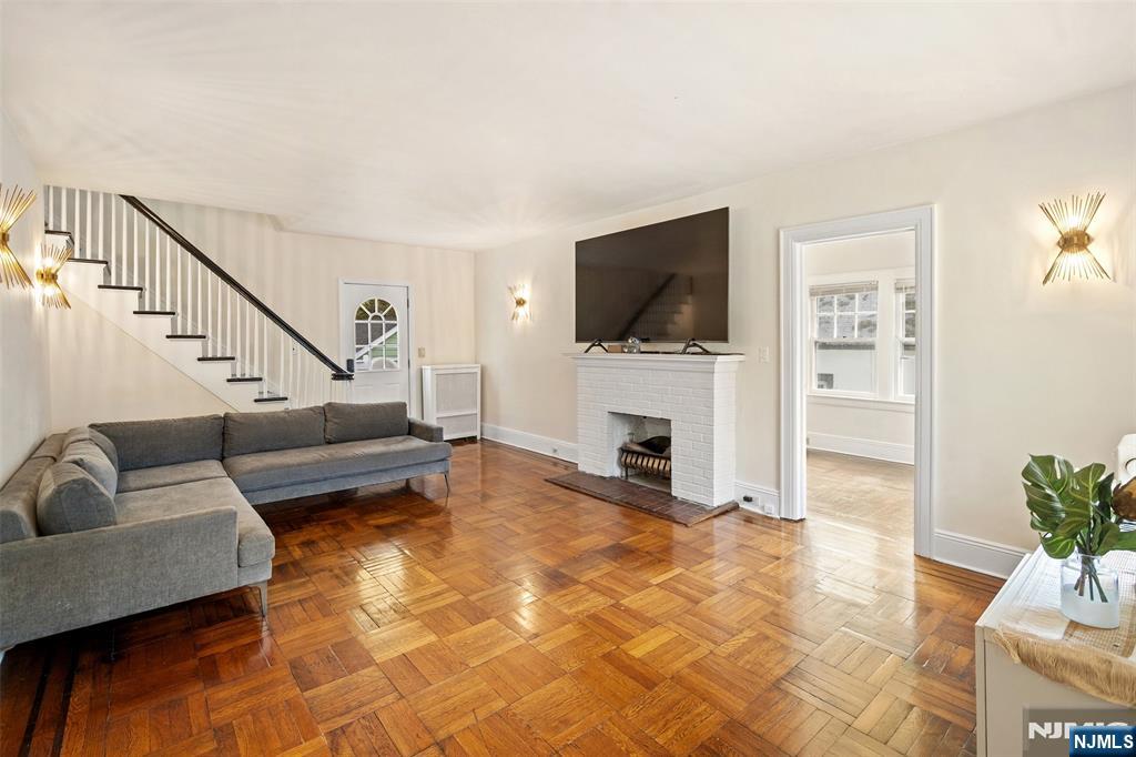 401 Conrad Road Englewood, NJ 07631 - Photo 10 of 42 a living room with furniture a flat screen tv and a fireplace