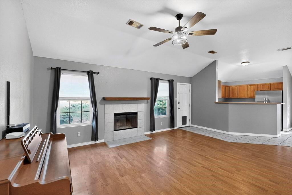 109 Pleasant Run Azle, TX 76020 - Photo 11 of 40 a view of an empty room with window and wooden floor