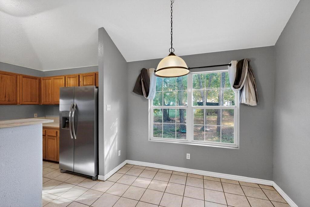 109 Pleasant Run Azle, TX 76020 - Photo 14 of 40 a view of an empty room with windows & cabinet