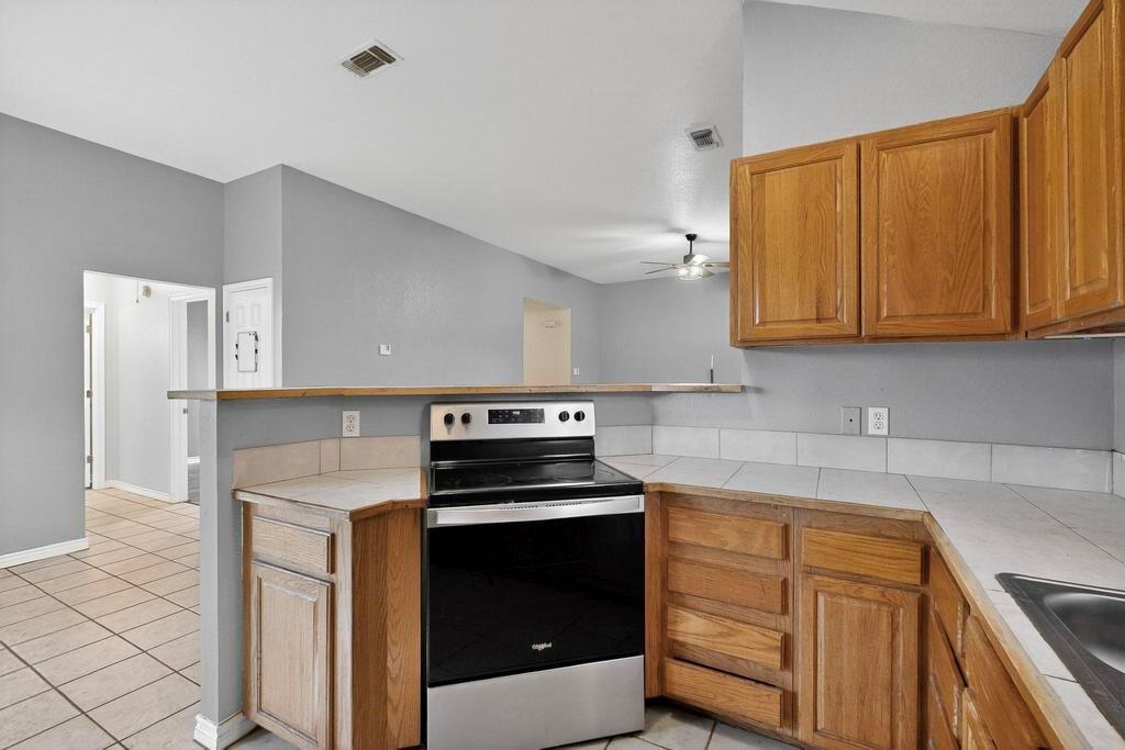 109 Pleasant Run Azle, TX 76020 - Photo 16 of 40 a kitchen with cabinets stainless steel appliances and sink