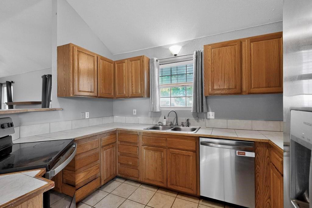 109 Pleasant Run Azle, TX 76020 - Photo 17 of 40 a kitchen with a sink cabinets and window