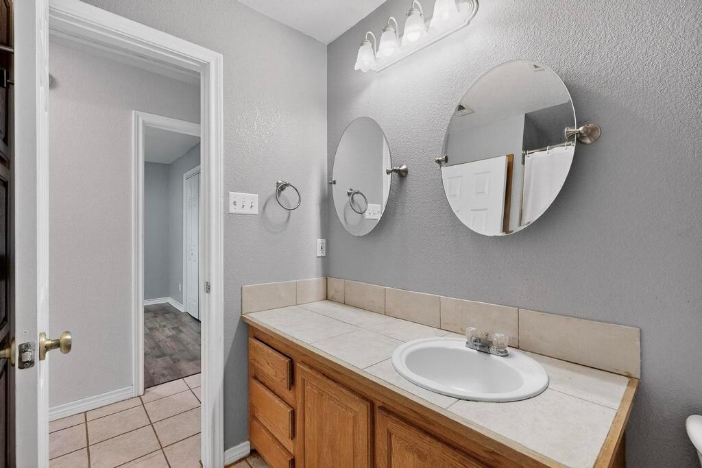 109 Pleasant Run Azle, TX 76020 - Photo 19 of 40 a bathroom with a sink double vanity and a mirror