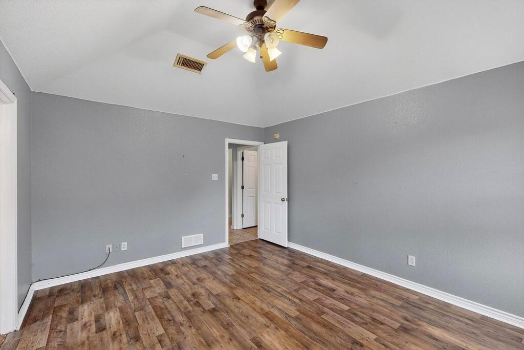 109 Pleasant Run Azle, TX 76020 - Photo 21 of 40 a view of a room with a ceiling fan and wooden floor