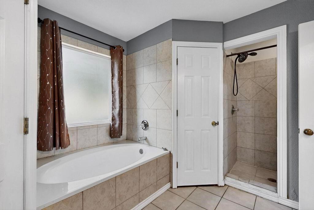 109 Pleasant Run Azle, TX 76020 - Photo 24 of 40 a bathroom with a tub shower and sink