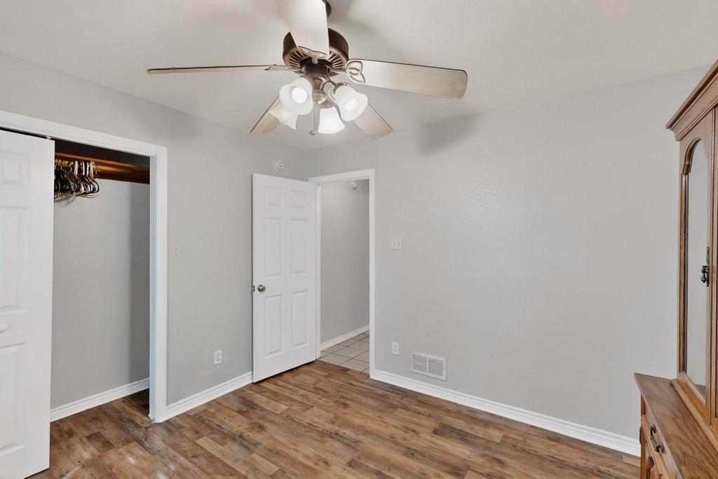 109 Pleasant Run Azle, TX 76020 - Photo 27 of 40 a view of an empty room with wooden floor