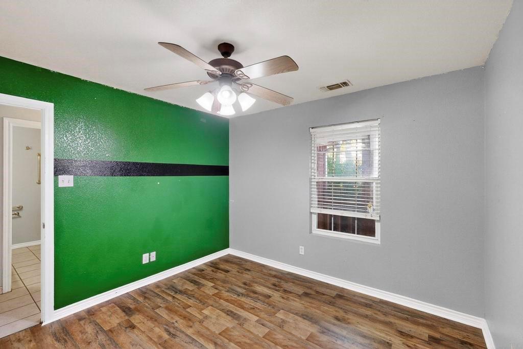 109 Pleasant Run Azle, TX 76020 - Photo 28 of 40 a view of an empty room with a window and a ceiling fan