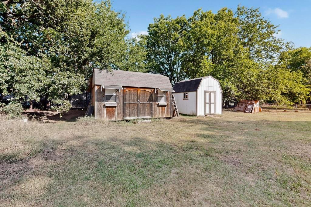 109 Pleasant Run Azle, TX 76020 - Photo 34 of 40 a view of a house with a yard and garage