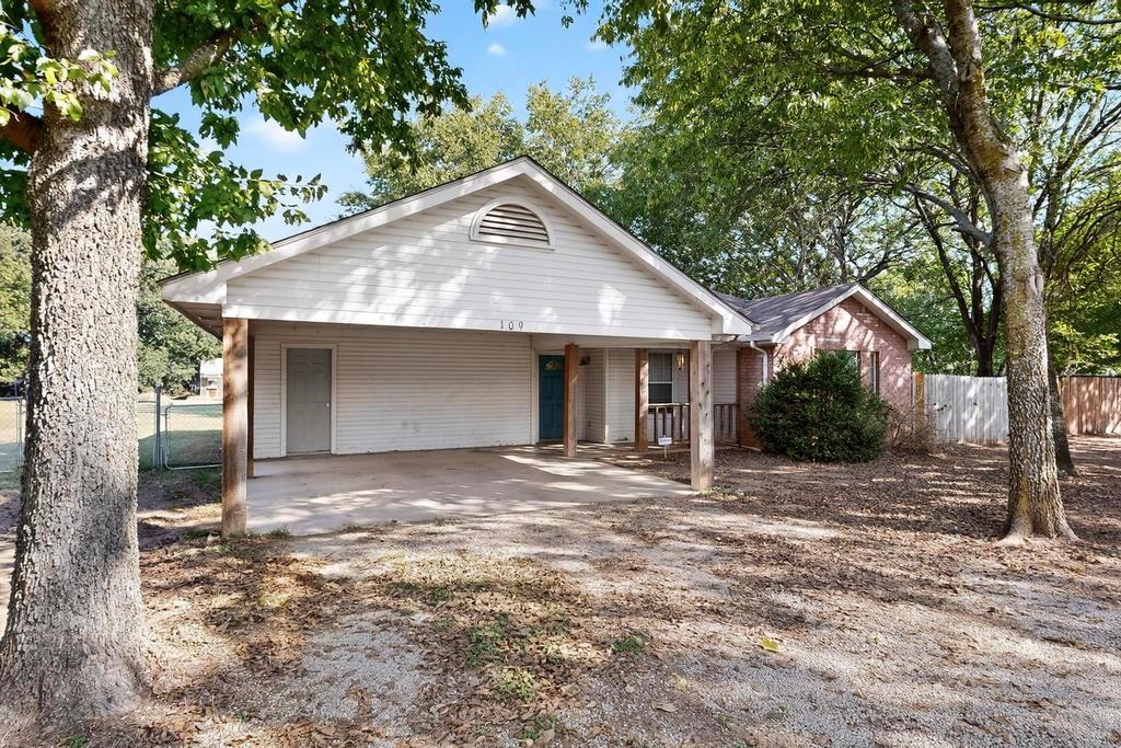 109 Pleasant Run Azle, TX 76020 - Photo 7 of 40 a front view of a house with yard and trees