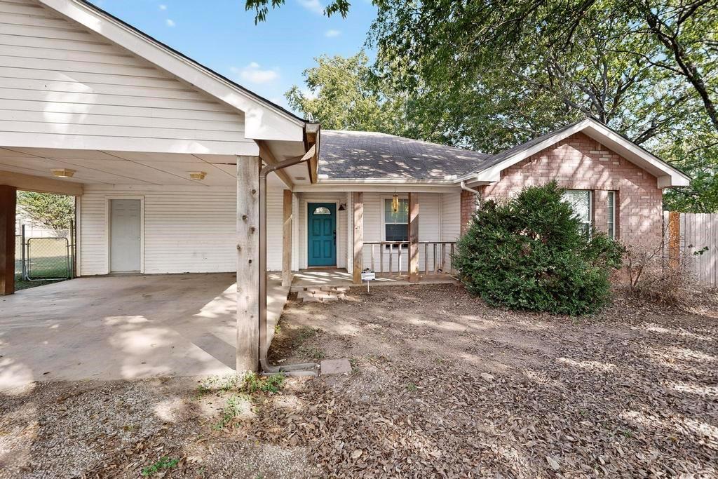 109 Pleasant Run Azle, TX 76020 - Photo 8 of 40 a view of a house with a yard and plants