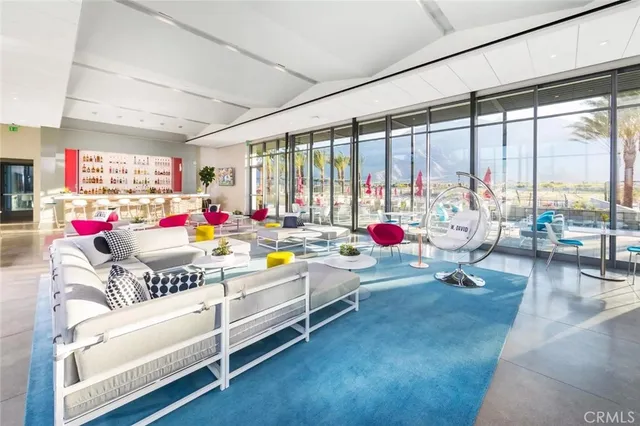 a playing room with furniture and a large window