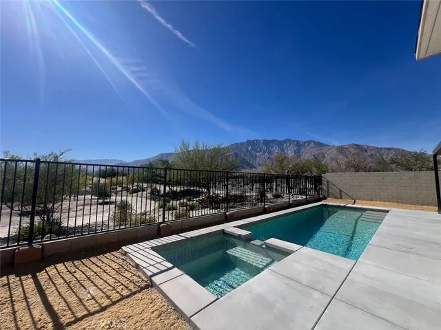 a view of a swimming pool and lounge chair