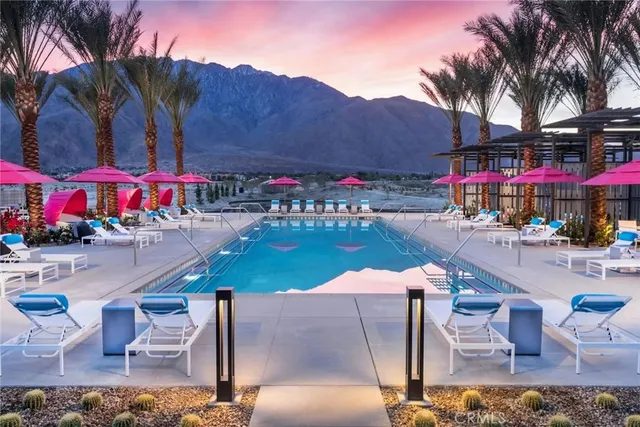 a view of a swimming pool and lounge chairs