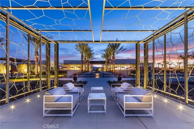 a view of a patio with a dining table and chairs with wooden floor