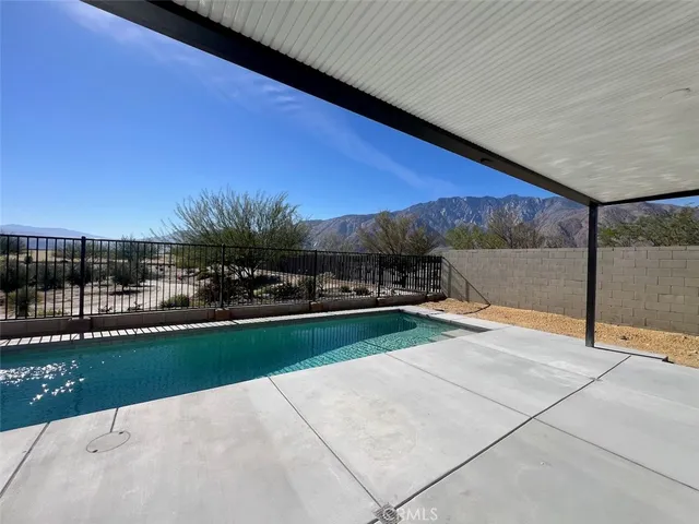 a large kitchen with stainless steel appliances a large counter top and a stove