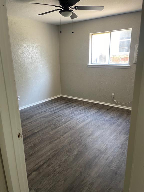 5526 Reiger Avenue, Unit 109 Dallas, TX 75214 - Photo 11 of 13 a view of an empty room with a window and wooden floor