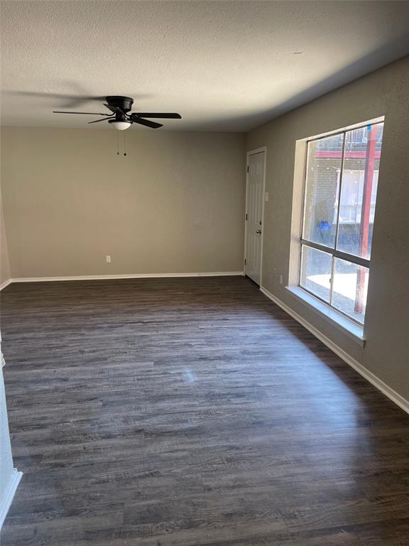 5526 Reiger Avenue, Unit 109 Dallas, TX 75214 - Photo 6 of 13 wooden floor in an empty room with a window