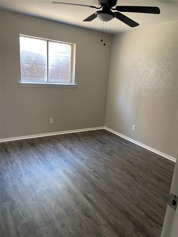 5526 Reiger Avenue, Unit 109 Dallas, TX 75214 - Photo 8 of 13 wooden floor in an empty room with a window